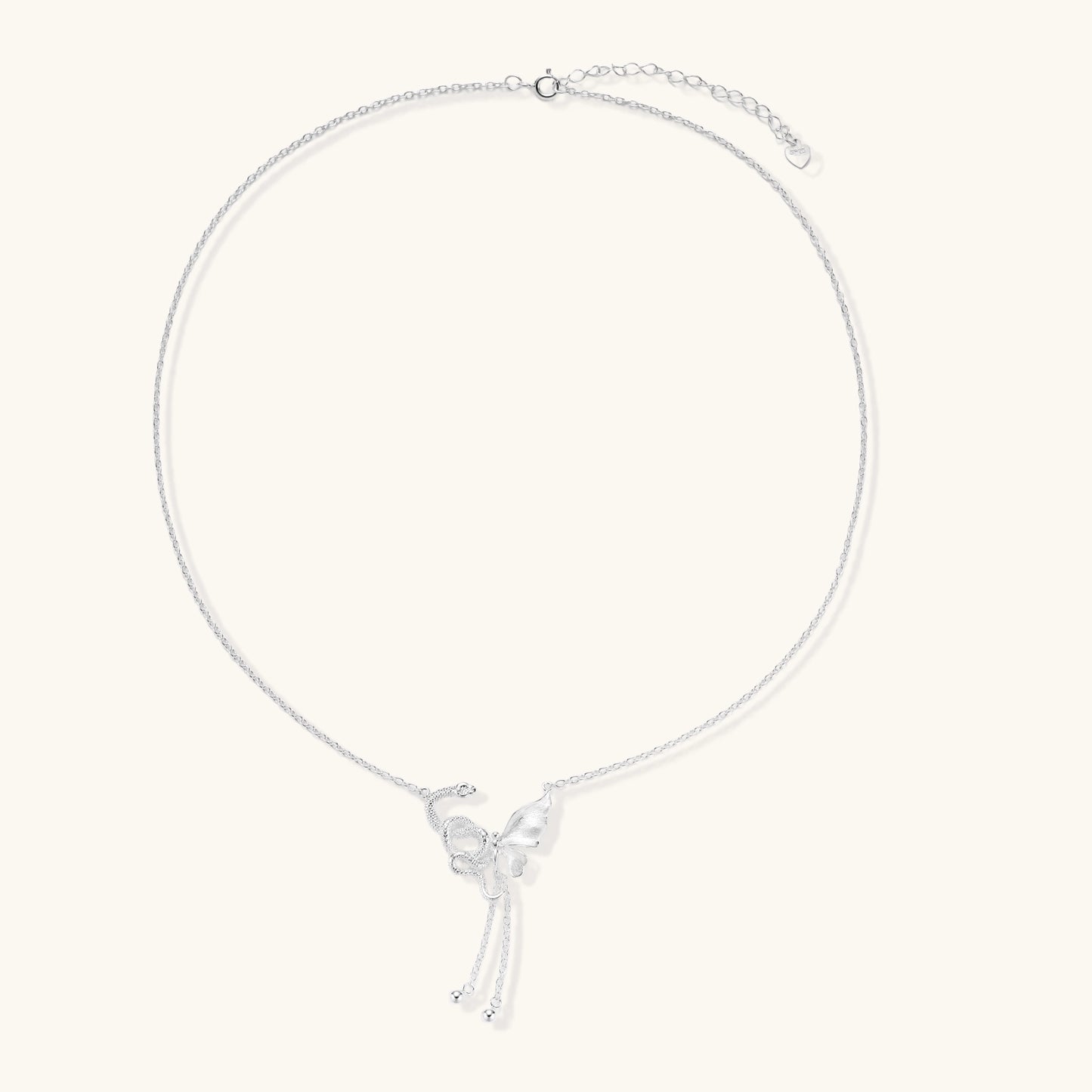 Delicate sterling silver butterfly pendant necklace with textured wing details and adjustable chain on white background
