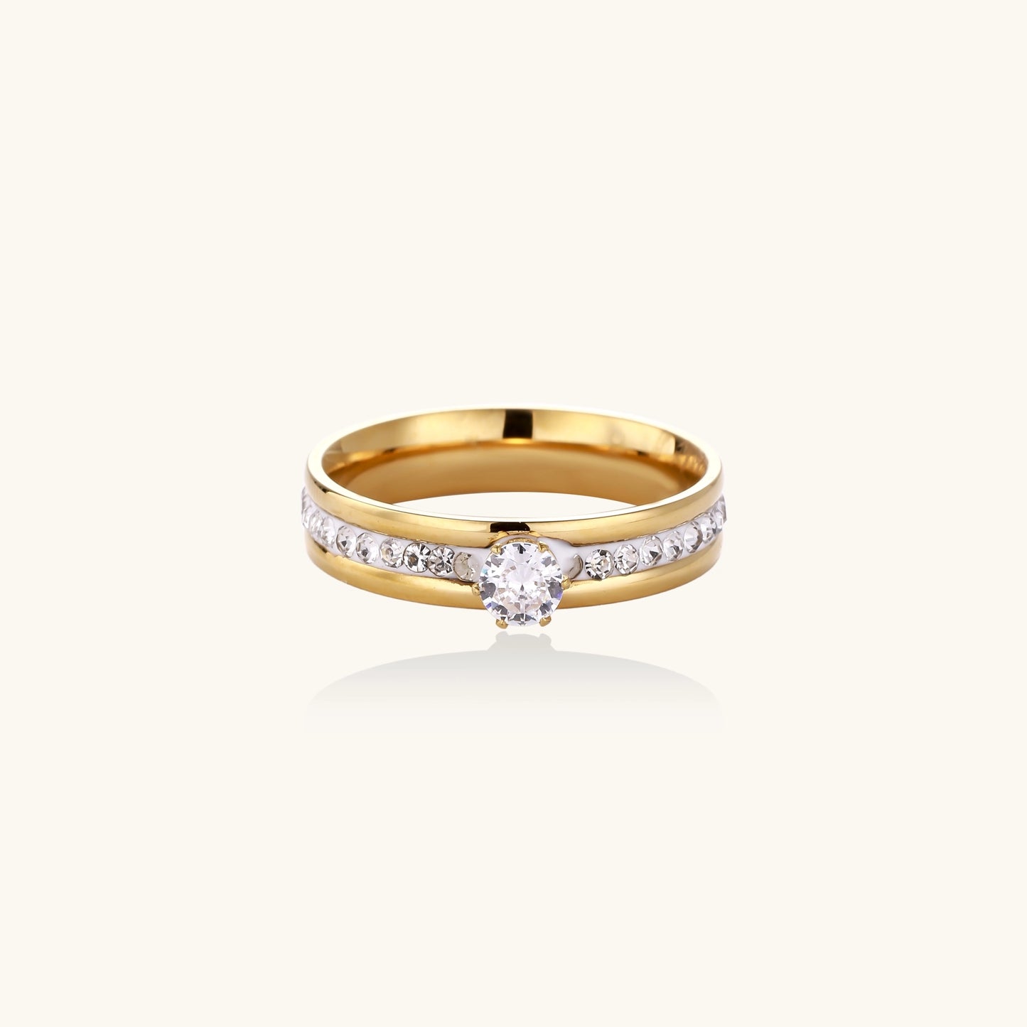 14K gold plated ring with center rhinestone and accent stones along the band on white background.