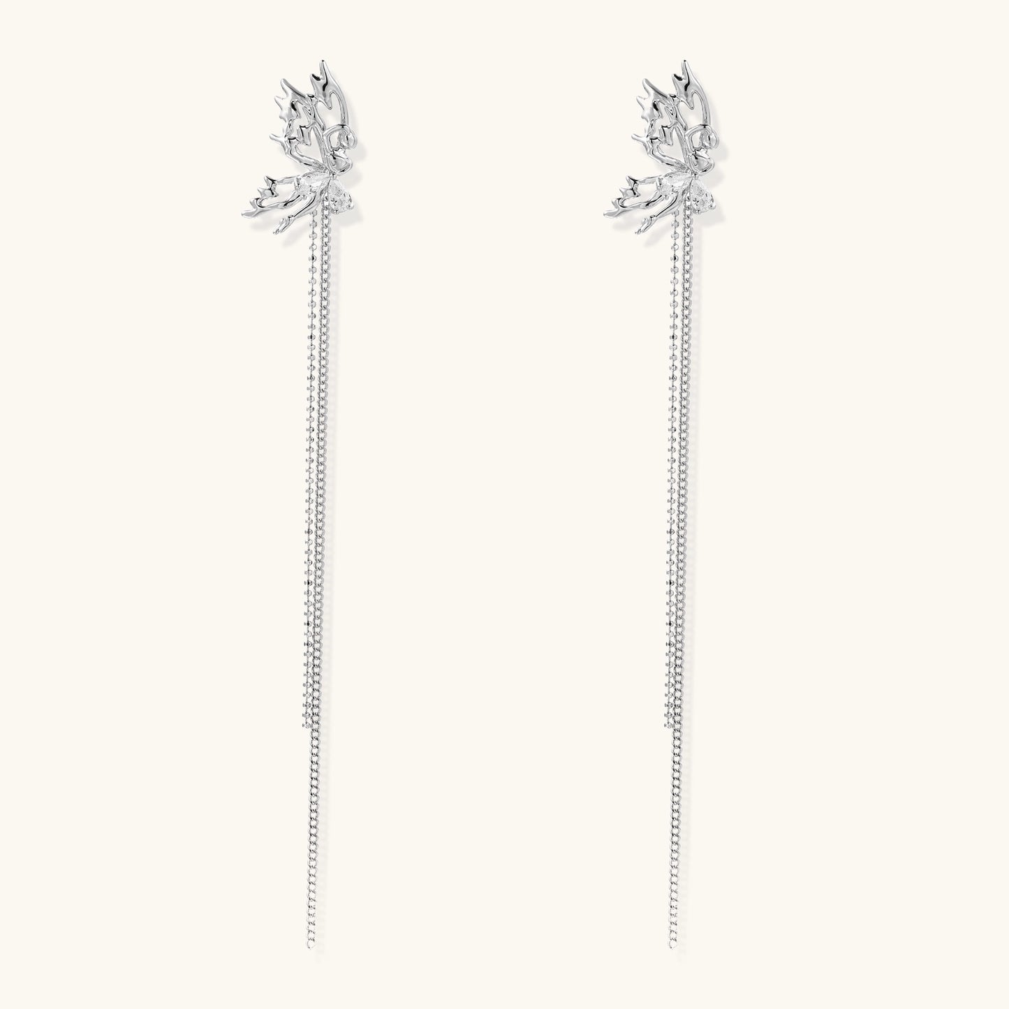 Long gold-plated earrings with star motifs and delicate chain tassels cascading down, featuring zirconia accents.