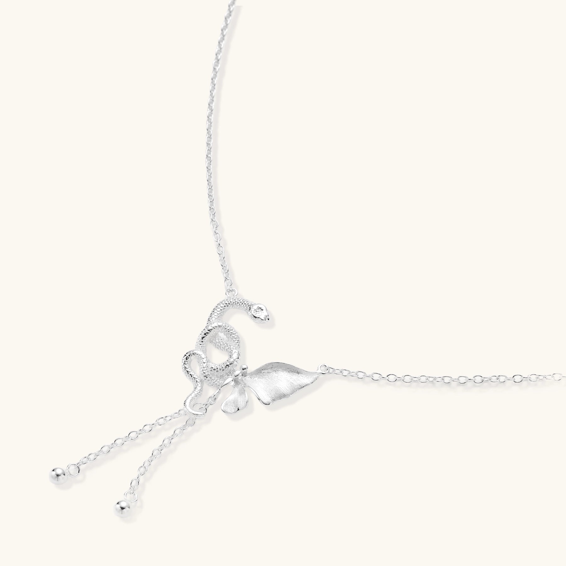 Delicate sterling silver butterfly pendant necklace with textured wing details and adjustable chain on white background