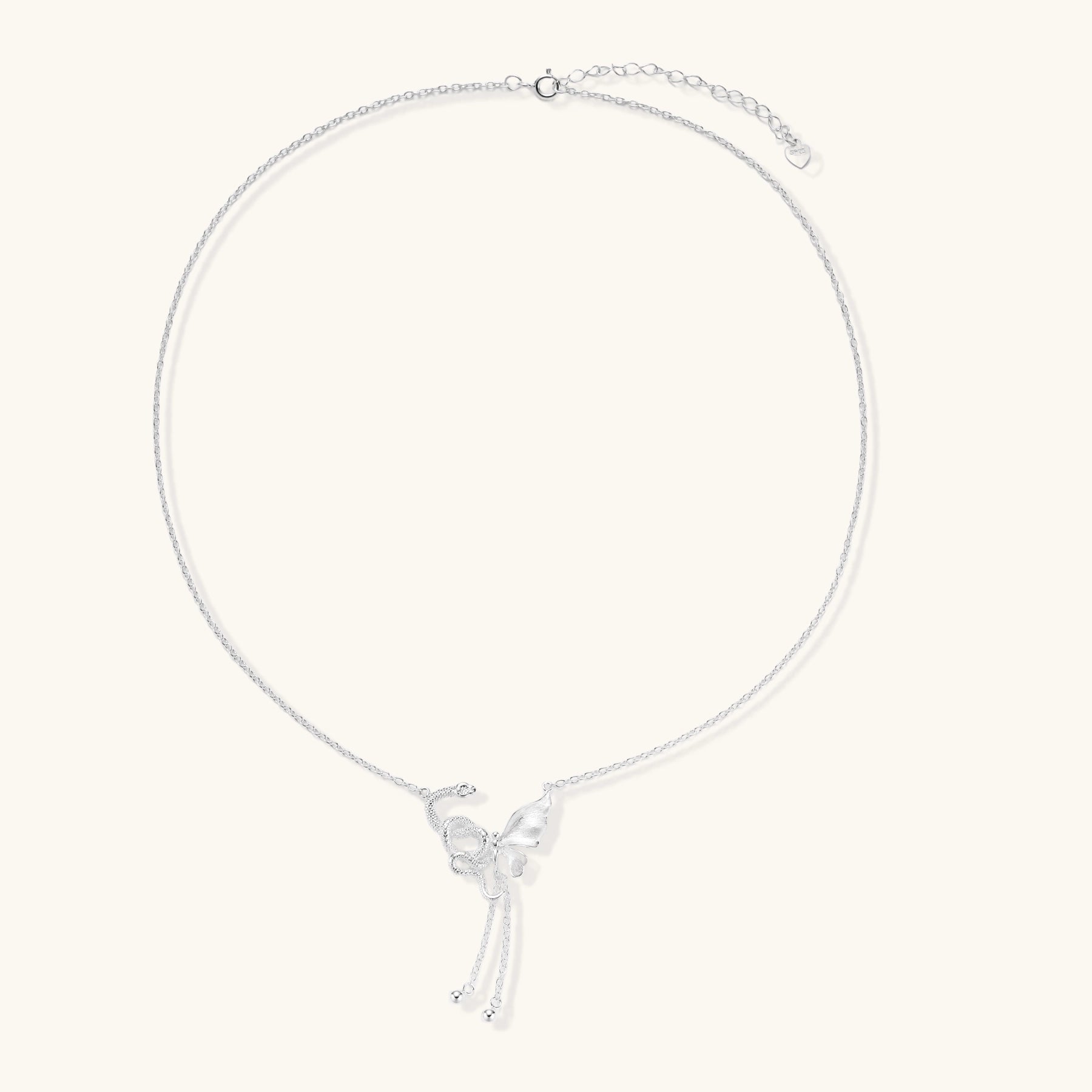 Delicate sterling silver butterfly pendant necklace with textured wing details and adjustable chain on white background