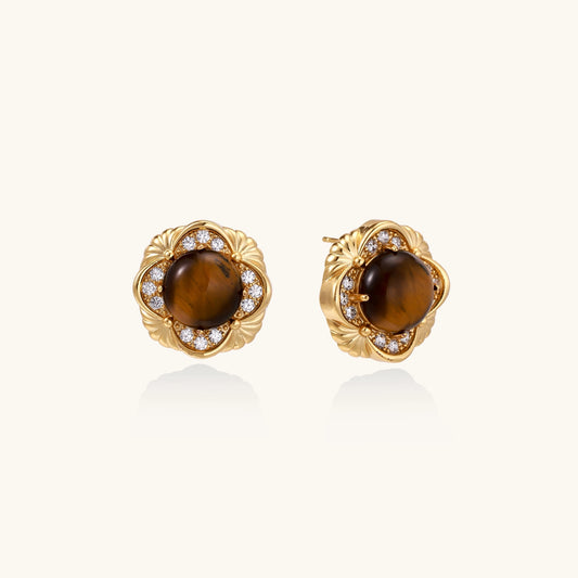 Ornate gold-plated brass stud earrings featuring round tiger's eye stones surrounded by sparkling zirconia in floral design