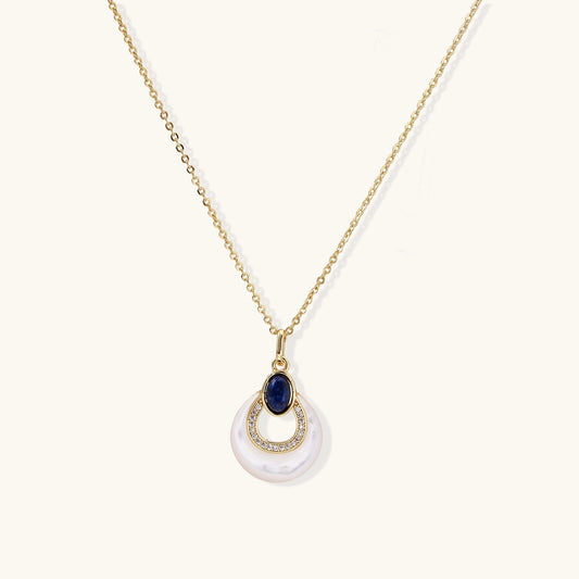 Layered pendant necklace with deep blue lapis lazuli stone, crystals, and white mother of pearl on 18k gold plated chain